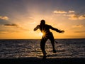 Silhouette of Man on the Beach at Sunset Royalty Free Stock Photo