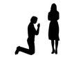 Silhouette of man beg on his knees in front of woman