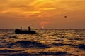 Silhouette of man in boat and parachute in sky Royalty Free Stock Photo