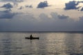 Silhouette of a man on a boat during sunset at sea Royalty Free Stock Photo