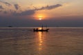 Silhouette of a man on a boat during sunset at sea Royalty Free Stock Photo