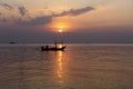 Silhouette of a man on a boat during sunset at sea Royalty Free Stock Photo