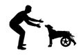 Silhouette Man calling for a paralyzed dog in a wheelchair