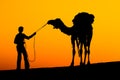 Silhouette man and camel Royalty Free Stock Photo