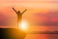 Silhouette of Man Celebration Success Happiness on a Stone Evening Sky Sunset at Beach Background, Sport and active life Concept Royalty Free Stock Photo