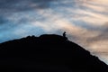 Silhouette of a man with a cell phone on a mountain