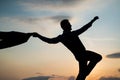 silhouette of man dancing in sense of freedom on sunrise sky, free