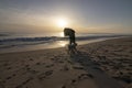 The silhouette of a man and a dog walking in a beautiful sunset on the beach of MatalascaÃÂ±as, Huelva, Spain. Royalty Free Stock Photo