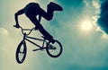 Silhouette of a man doing an BMX extreme jump. Royalty Free Stock Photo