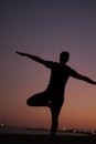 Silhouette of man doing yoga on the beach Royalty Free Stock Photo