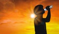 Silhouette man is drinking water bottle on hot weather background with summer season. High temperature and heat wave concept