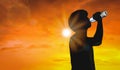 Silhouette man is drinking water bottle on hot weather background with summer season. High temperature and heat wave concept Royalty Free Stock Photo