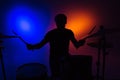 Silhouette of man drummer sitting and playing drums with sticks Royalty Free Stock Photo