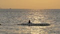 Silhouette of a man fishing on the displacer at Sunset. Pattaya, Thailand