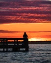 Silhouette of a man fishing on the Field 10 piers at Jones Beach State Park at sunset. Long Island Royalty Free Stock Photo