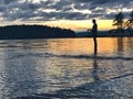 The silhouette of a man fishing