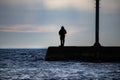 Silhouette of a man fishing off of a pier on Lake Michigan Royalty Free Stock Photo