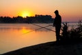 Silhouette of man fishing in a sunset Royalty Free Stock Photo