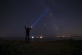 Silhouette of man with flashlight beaming ray to Milky Way galaxy Royalty Free Stock Photo