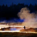 Silhouette of Man Flyfishing Fishing in River Golden Sunlight Royalty Free Stock Photo