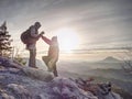 Silhouette man and girlfriend shooting sunset on top