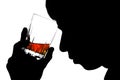 Silhouette of a man with a glass of cognac on his forehead