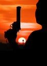 silhouette of man hand holding gun revolvers Royalty Free Stock Photo