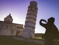 Silhouette man hand he`s a take a picture by smartphone at  Leaning tower in Pisa old town in Italy Royalty Free Stock Photo
