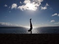 Silhouette of Man Handstands at sunset on an empty Beach Royalty Free Stock Photo