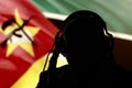 Silhouette of a man in headphones on the background of the flag of Mozambique eavesdropping conversation, secret agent, spy and sc