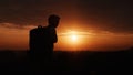 Silhouette of man hiker standing on rocky mountain peak with sunset golden sky feeling of freedom Royalty Free Stock Photo