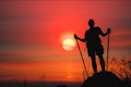 Silhouette of man hiker standing on rocky mountain peak with sunset golden sky feeling of freedom Royalty Free Stock Photo