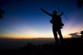 Silhouette of man hiking on top mountain trees forest with light during sunset Royalty Free Stock Photo