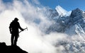 Silhouette of man with ice axe in hand and mountains Royalty Free Stock Photo