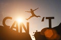 Silhouette man jump between can`t wording and can wording on mountain. Mindset for career growth business