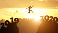 Silhouette man jump between 2019 and 2020 years. Happy new year 2020 concept for achievement Royalty Free Stock Photo