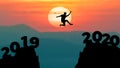 Silhouette man jump between 2019 and 2020 years. Happy new year 2020 concept for achievement
