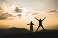 Silhouette of a man jumping with arms and legs spread as the sun sets. Success concept. journey for freedom Travel, adventure,