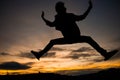 Silhouette of man jumping with sunset sky for background Royalty Free Stock Photo