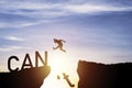 Silhouette man jumping from can`t cliff to can cliff , Change Mindset concept