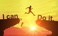 Silhouette of man jumping and change i can\'t do it to i can do it text on Mountain, sky and sun light background. Motivation Royalty Free Stock Photo
