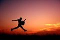 Silhouette man jumping with guitar Royalty Free Stock Photo