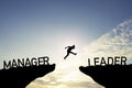 Silhouette Man jumping from Manager cliff to leader cliff on cloud and blue sky. Change behaviour and mindset to Leadership