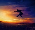 Silhouette of man jumping off a cliff Royalty Free Stock Photo