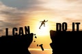 Silhouette man jumping over cliffs for I can do it , good mindset by never give up concept