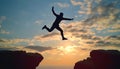 Silhouette man jumping over cliffs for I can do it , good mindset by never give up concept Royalty Free Stock Photo