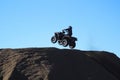 silhouette of a man jumping with a quad against a blue sky Royalty Free Stock Photo