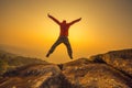 Silhouette man jumping into sunset sky