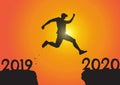 Silhouette of man jumping from 2019 to 2020 on sunrise background, successful new year concept Royalty Free Stock Photo
