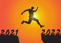 Silhouette of man jumping from 2021 to 2022 on sunrise background, successful new year concept